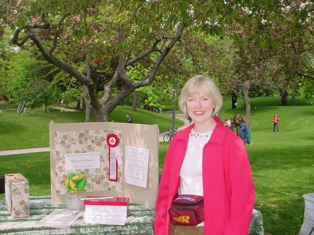 Helen displaying award-winning quilt